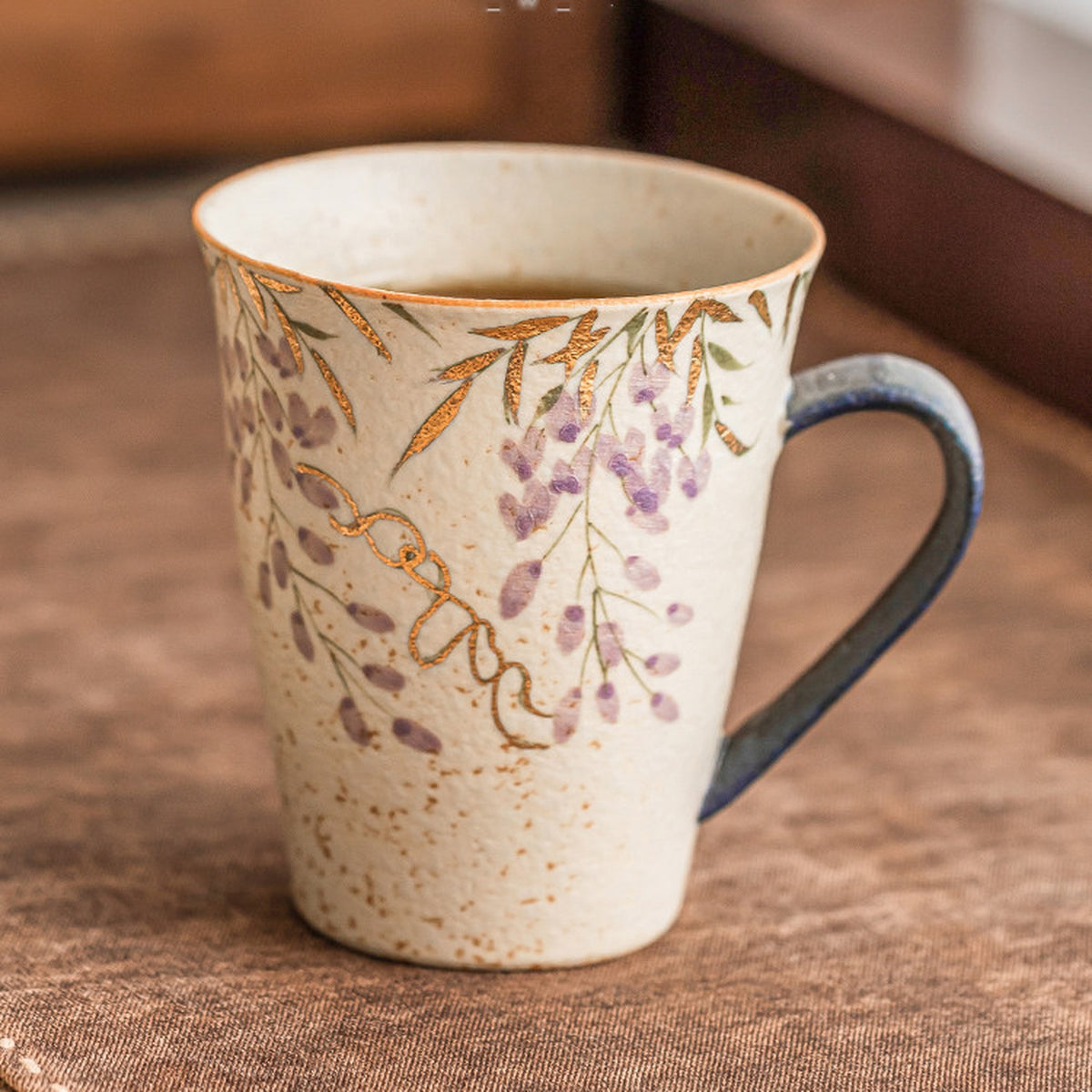 Hand-painted blue-fire wisteria ceramic mug with gold trim