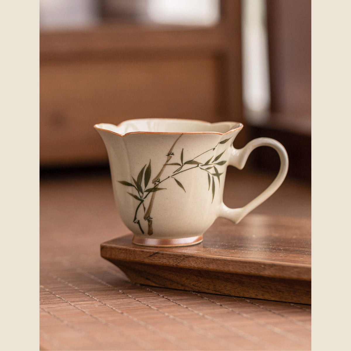 Hand-painted green bamboo ceramic tea cup with heart-shaped handle